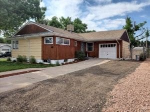 A house with a driveway and garage in front of it.