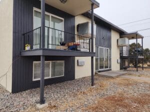 Two-story apartment building with a balcony.