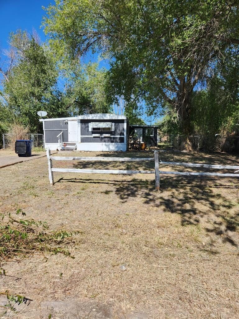 Mobile home with a wooden fence.